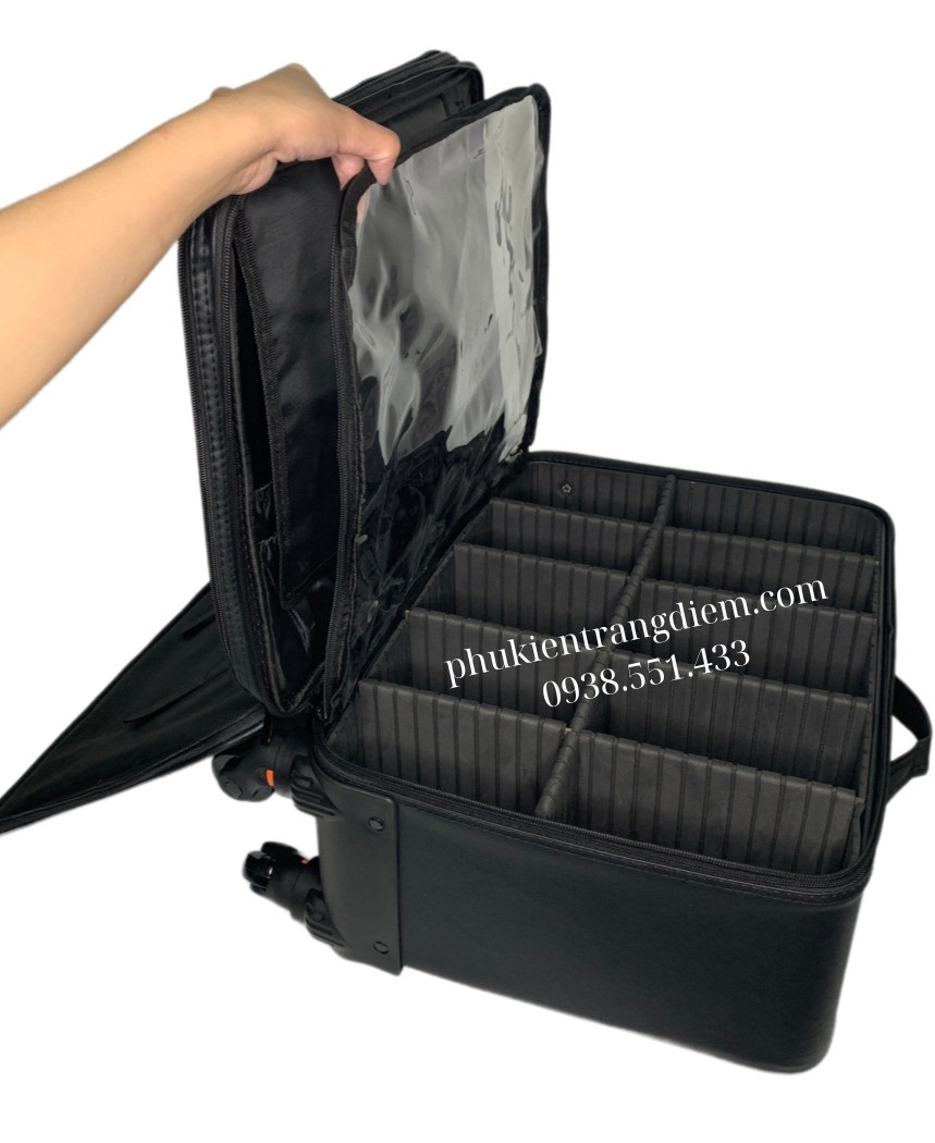cốp đựng đồ trang điểm size trung bình có bánh xe kéo vỏ da màu đen